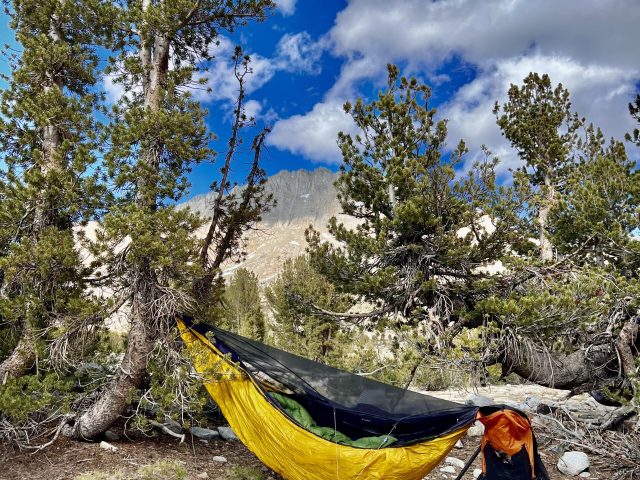 Crossing the high passes of the southern Sierra in May, it is essential to camp high, wake early, and get over them before the sun softens the snow to extra danger. Here I camped above easily hammockable trees to enable that early crossing. It dropped to 15ºF that night, fortunately no wind. I woke covered in thick frost, however. I waited to pack up until the sun sublimated away the frost. The cold snap meant the higher snow was still crispy hours after sunrise.