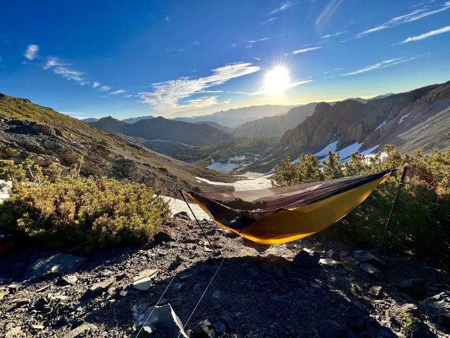 Around 10,500'. It was a windy night, but not too cold, and the hammock's tie-outs kept the swaying manageable. This was the only overnight two-pole hang north of the desert, as trees were usually available. Here I chose to hike past the trees for this morning view, to say nothing of <a href="https://www.tensaoutdoor.com/wp-content/uploads/2022/09/IMG_3402-scaled.jpeg">the jaw-dropping sunset</a>. Besides, there was the first signal in days available on this tree-bare side of the ridge. It was a challenging hang technically, on steep loose scree where no ground-dweller would ever think to camp, but I'd gotten very confident of my Treez hanging game by that point.